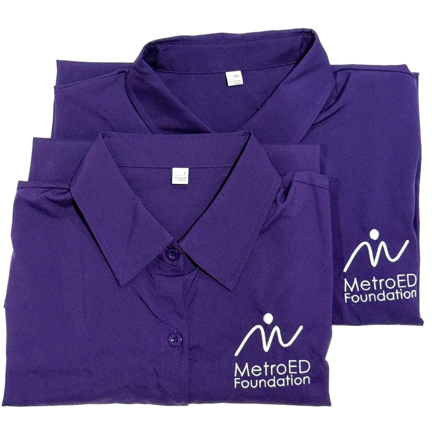 Folded purple shirts with MetroED Foundation logo on a white background